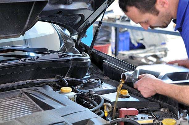 Volkswagen technician changing oil