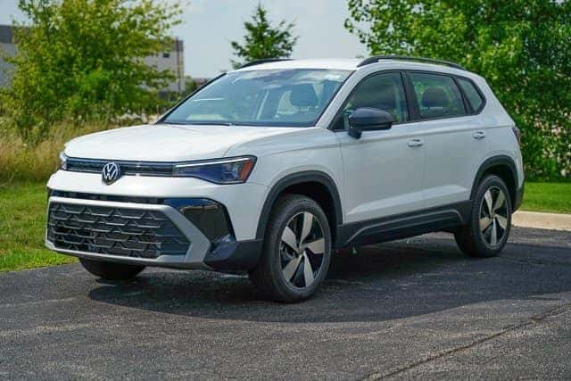 2025 Volkswagen Taos parked in front of Elgin Volkswagen dealership