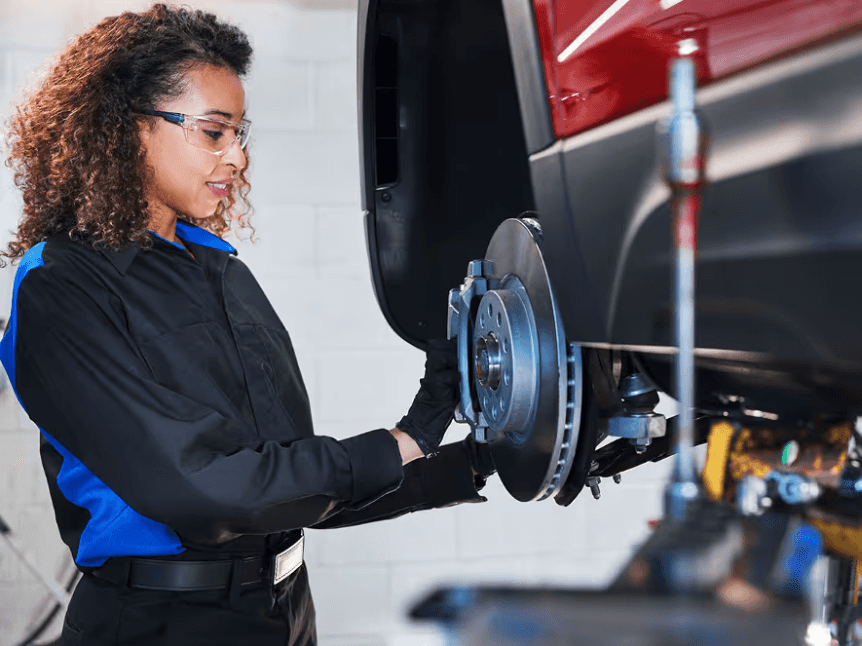Mechanic inspecting Volkswagen tires and brakes at Elgin VW