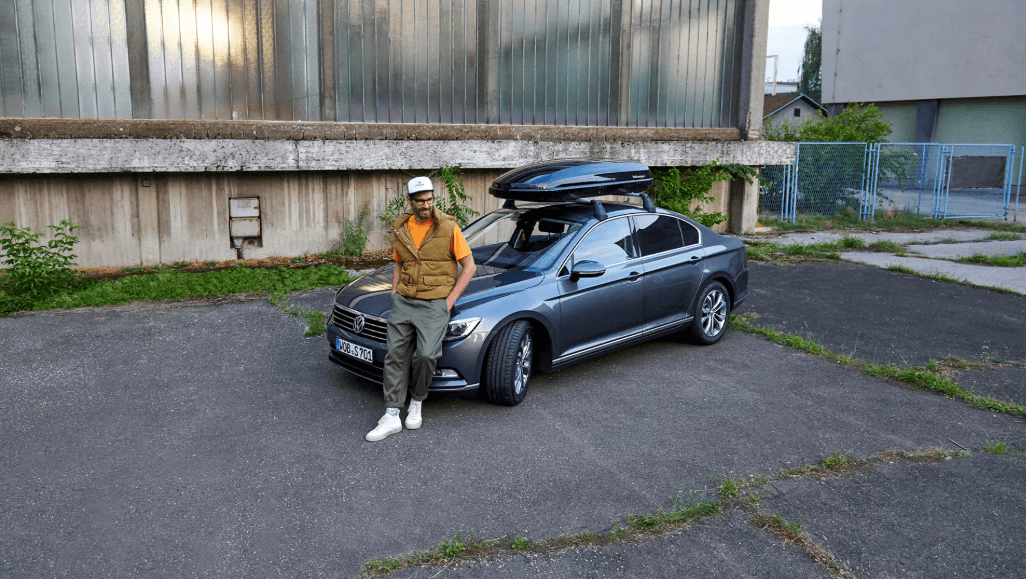 Driver with a certified pre-owned Volkswagen sedan equipped for travel