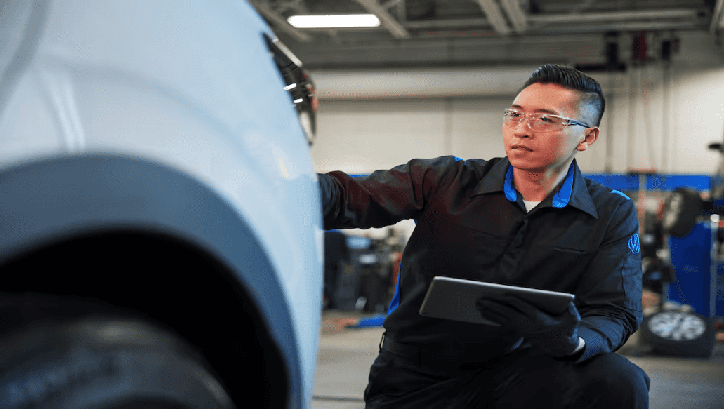 Volkswagen technician performing fall car maintenance at Elgin VW