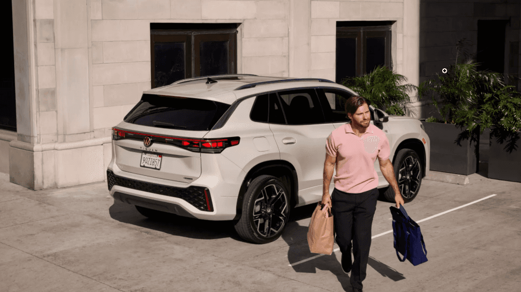 Certified pre-owned Volkswagen SUV parked while the driver unloads groceries