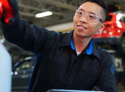 volkswagen technician performing seasonal fluid inspection