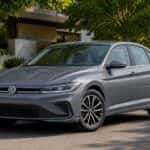 Volkswagen Jetta parked in shaded suburban neighborhood near houses and trees