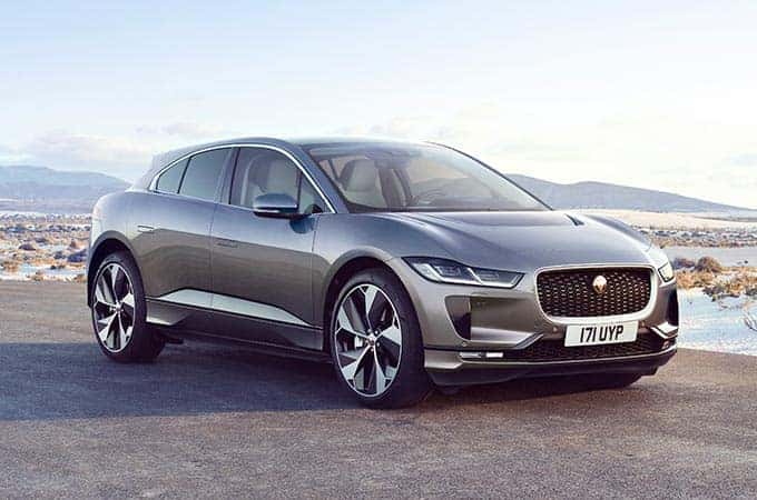 Grey 2022 Jaguar I-pace pared in a desert setting amongst a blue sky 