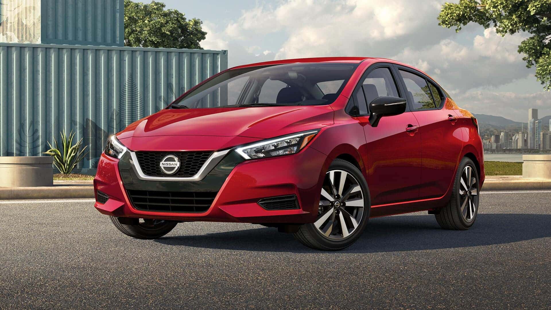 Red Nissan Versa parked on the street