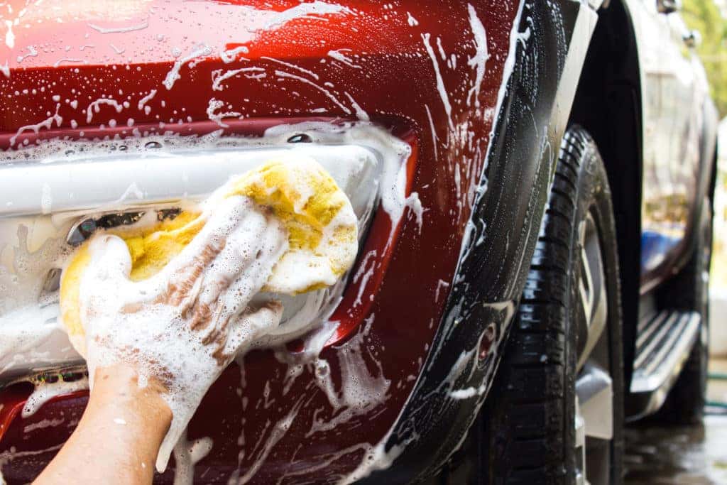A person cleaning their own car at home