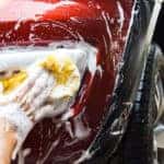 A person cleaning their own car at home
