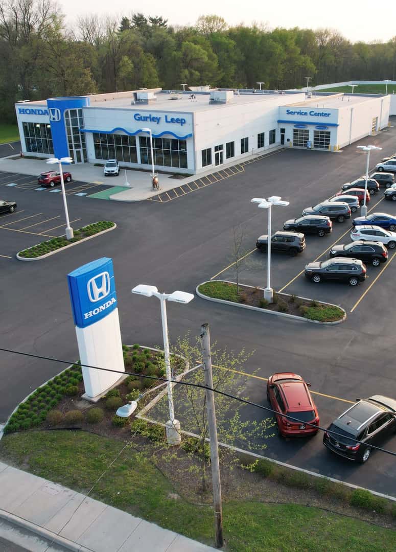 Exterior shot of a Honda vehicle parked on the side of a road.