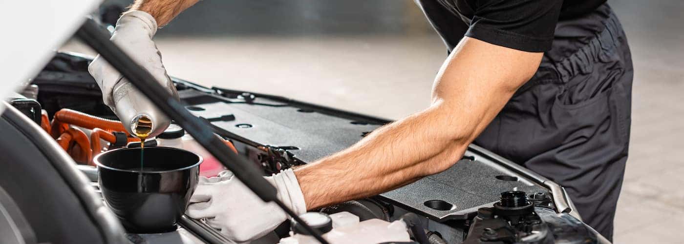 mechanic pouring new oil
