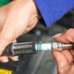 Mechaning Working on a Spark Plug