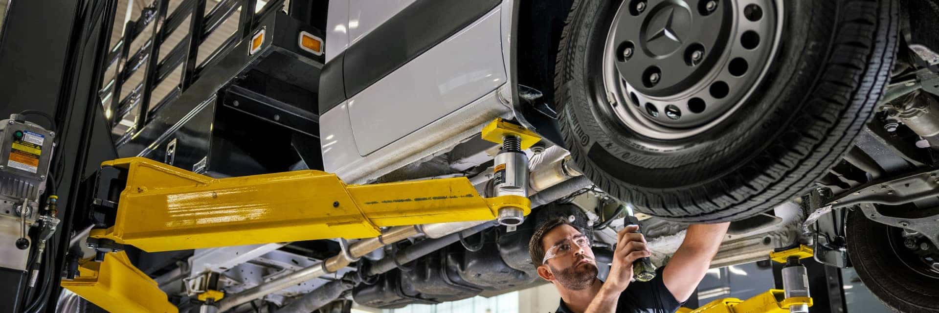 mercedes-benz service technician working on vehicle