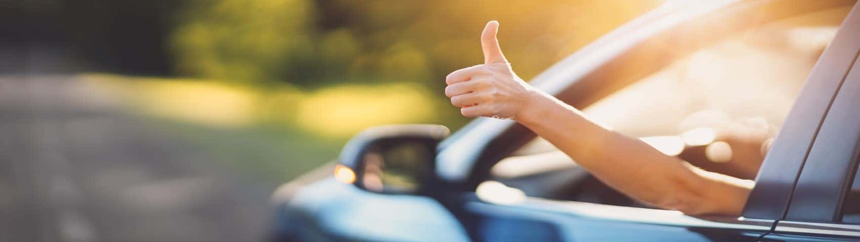 Driver giving a thumbs up out the window