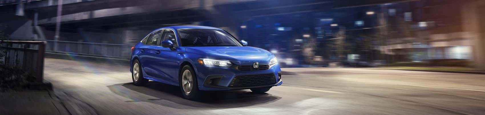 2022 Honda Civic blue driving on dark city streets
