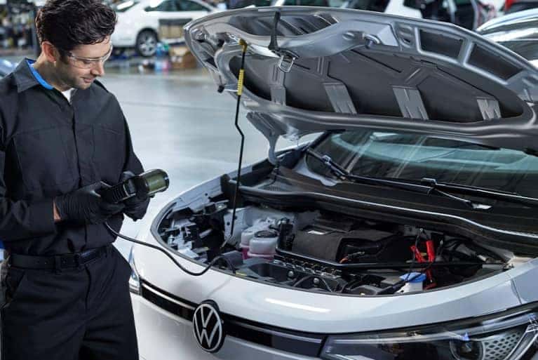 VW service tech running diagnostics on vehicle