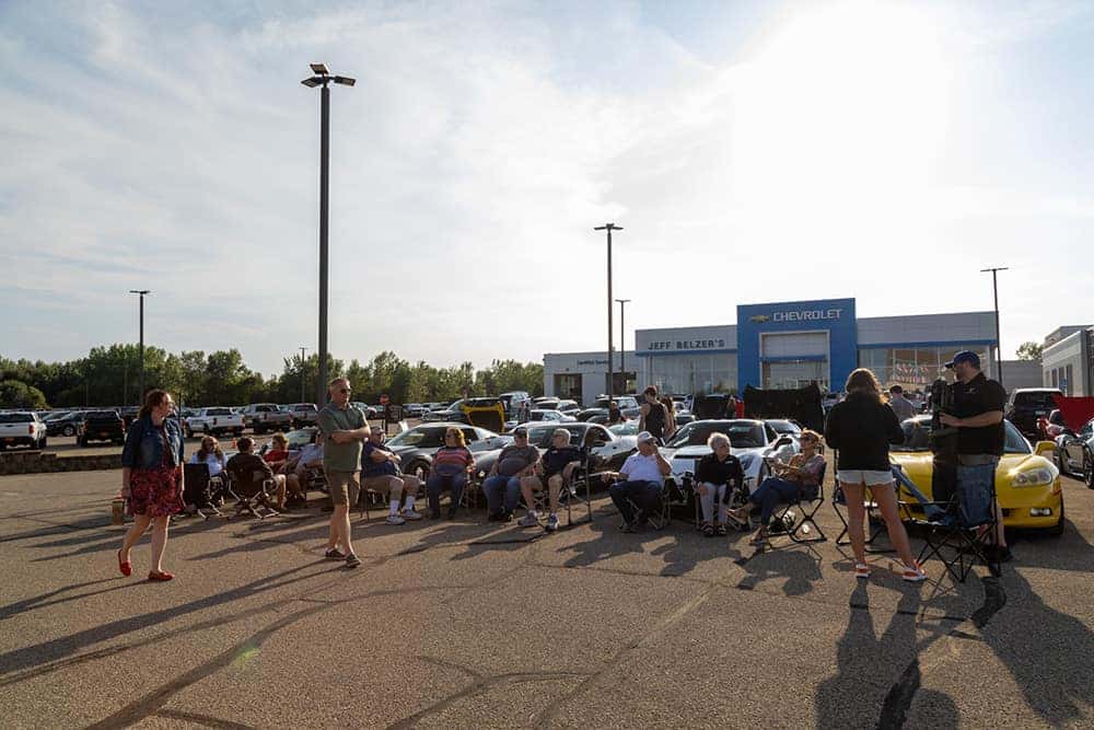 Corvette Lineup and People Gathered at Car Show