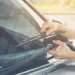 Hand picking up windscreen wiper