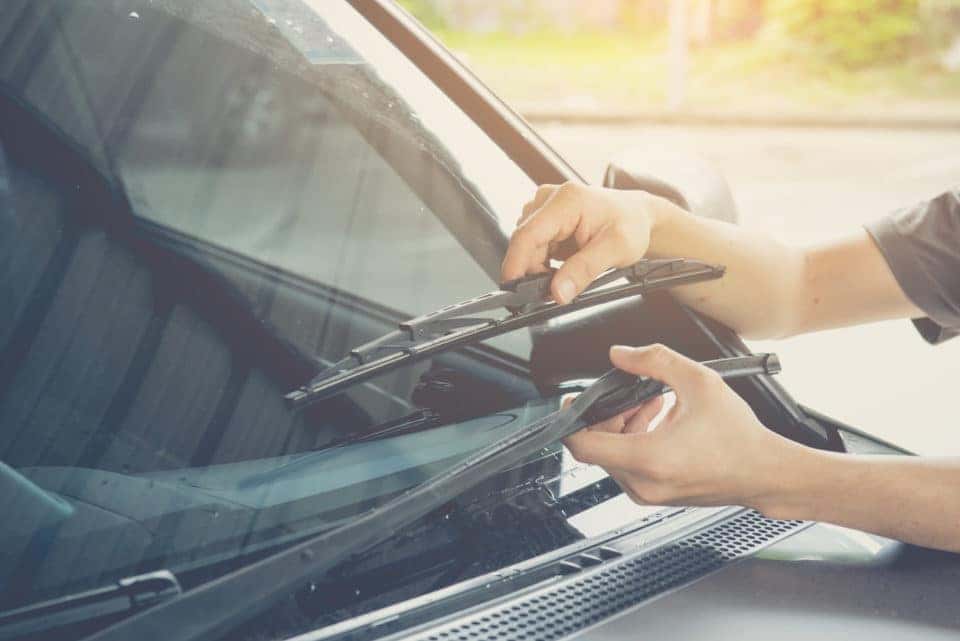 Hand picking up windscreen wiper