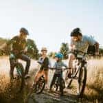 Family riding bikes on a trail