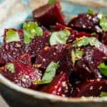 A bowl of beet salad with cilantro.