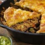 Layered, Beef Taco Pie Baked in a Cast Iron Skillet with Sour Cream, Salsa and Guacamole