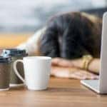 Woman struggling to stay awake at work