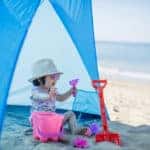 baby girl playing at summer beach