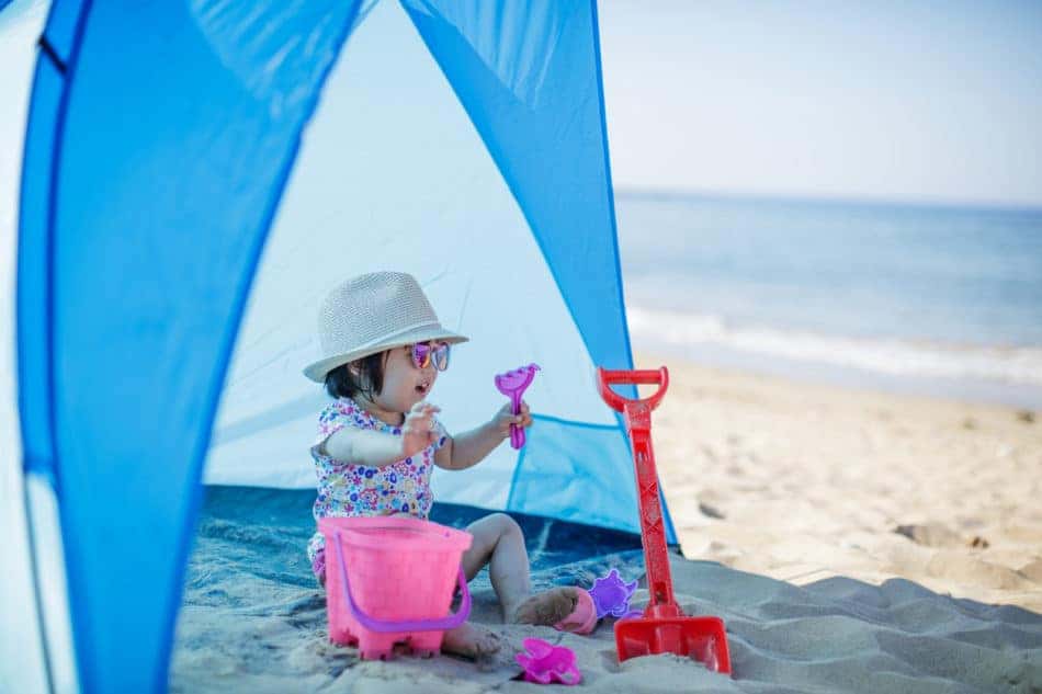 baby girl playing at summer beach
