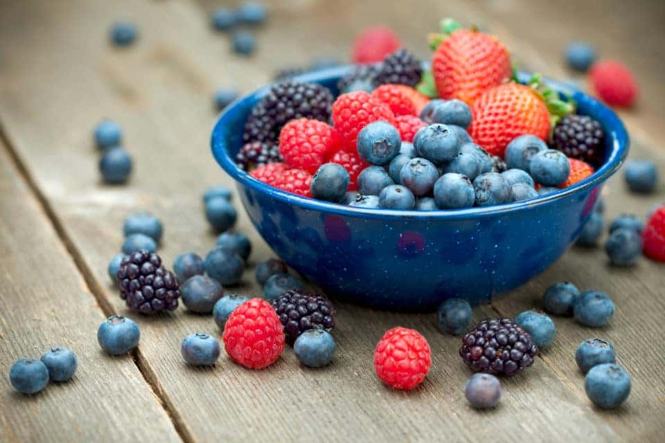 A bowlful of delicious organic berries. Strawberries, blackberries, blueberries and raspberries.