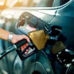 Hand refilling the car with fuel at the refuel station
