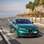 A sleek Alfa Romeo Tonale PHEV SUV parked against a scenic Italian backdrop, showcasing its elegant design and sporty features.