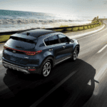 2020 Kia Sportage driving along a coastal road