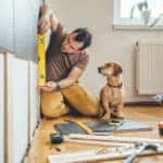 Man and dog working on DIY project