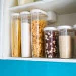 Pasta, buckwheat, rice, and sugar in plastic storage containers.