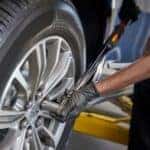 man working on tires in auto shop