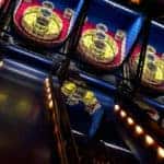 A series of skee-ball games lined up in an arcade.