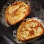 Cooking French Toast in cast iron skillet with butter