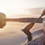 canoe paddle in lake at sunrise