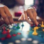 Close up of unrecognizable women playing board game.
