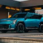2024 KIA EV9 parked under modern architecture