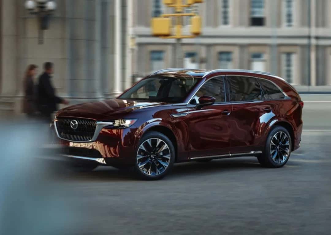 2025 Mazda CX-90 SUV driving through city streets