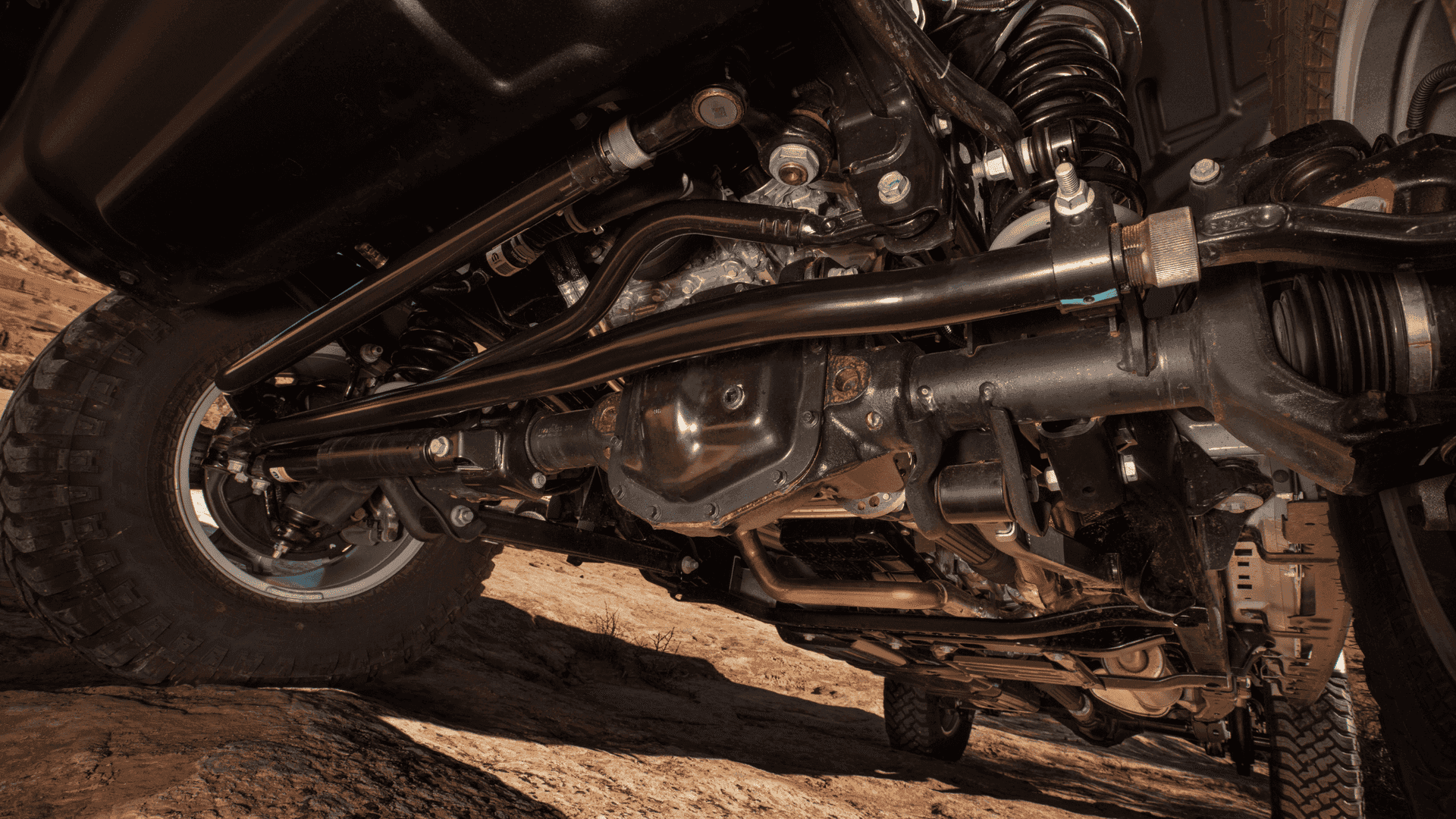 Close-up of the 2025 Jeep® Gladiator Mojave undercarriage showing off-road suspension and axles
