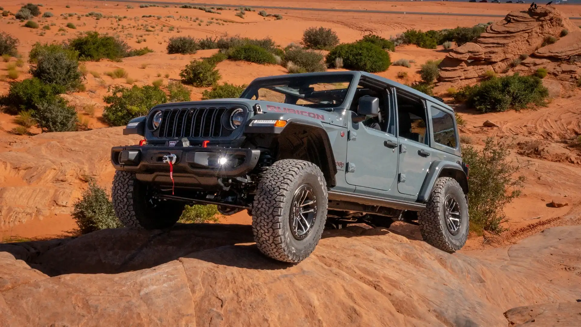 2025 Jeep Wrangler Rubicon navigating rocky terrain near Long Island with rugged off-road stance