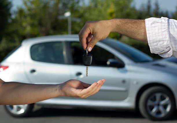Two hands with car keys