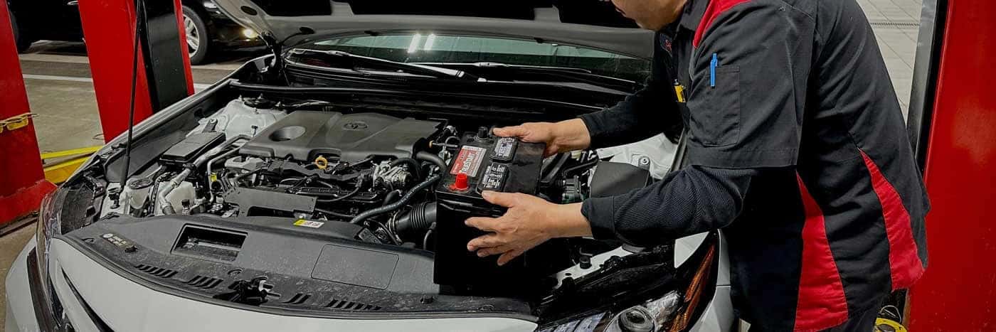 Toyota mechanic replacing a battery
