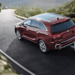Kia Sportage towing trailer on mountain highway