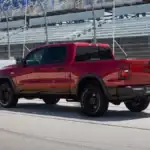 A red RAM 1500 driving on a race track