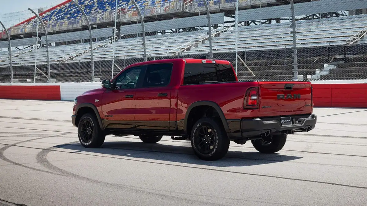 A red RAM 1500 driving on a race track