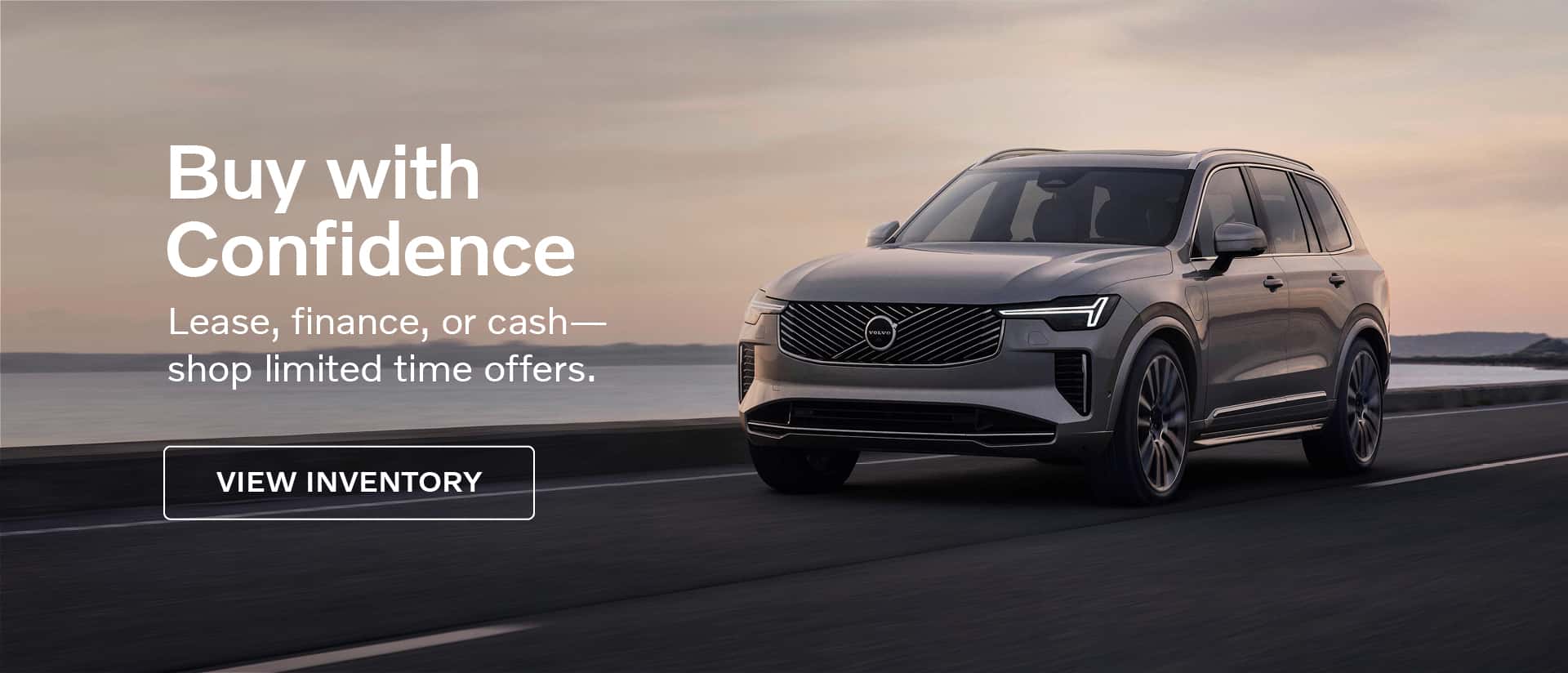 Volvo SUV driving along a coastal road at sunset with the text: 'Buy with Confidence. Lease, finance, or cash— shop limited time offers.' A button labeled 'View Inventory' is also visible.