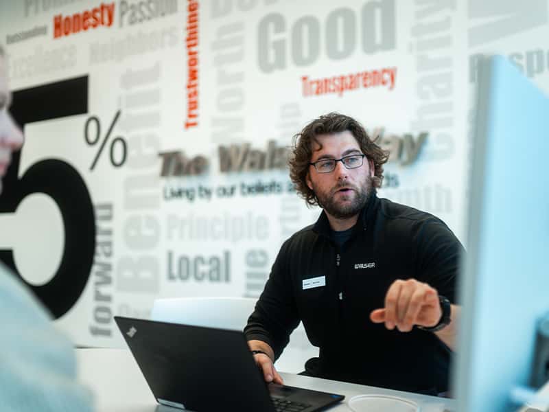 Dealership employee explaining tariffs